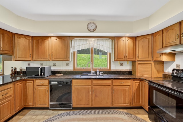 561 Toleman Rd, Rock Tavern, NY 12575 - kitchen featuring black appliances, under cabinet range hood, brown cabinetry, and dark stone countertops