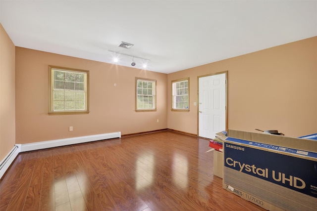 561 Toleman Rd, Rock Tavern, NY 12575 - spare room featuring track lighting, wood finished floors, and a baseboard radiator
