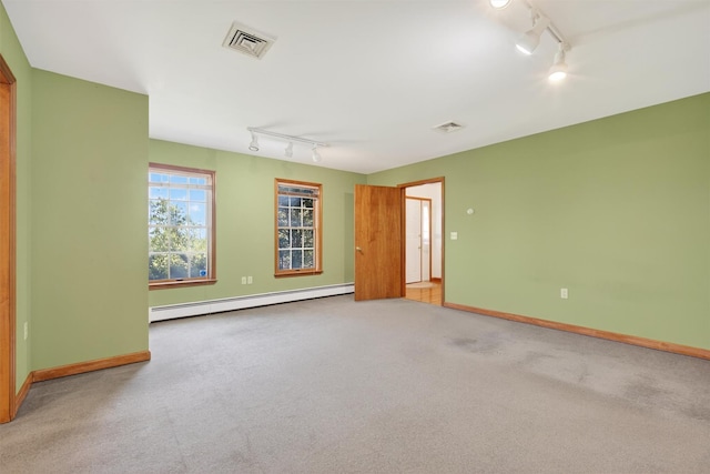 561 Toleman Rd, Rock Tavern, NY 12575 - carpeted empty room with track lighting and a baseboard radiator