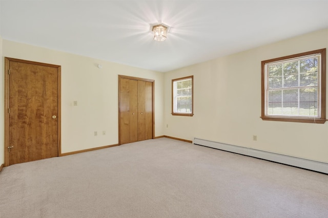 561 Toleman Rd, Rock Tavern, NY 12575 - unfurnished bedroom with light colored carpet, a closet, and baseboard heating