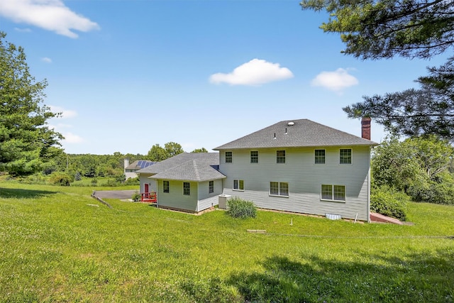 561 Toleman Rd, Rock Tavern, NY 12575 - rear view of house with a chimney and a yard