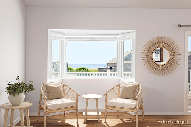 100 Deforest Rd Unit 701, Montauk, NY 11954 - living area featuring wood finished floors, plenty of natural light, and a water view