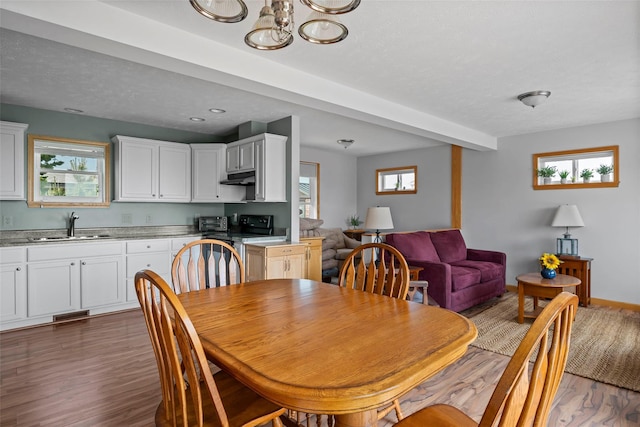 100 Deforest Rd Unit 701, Montauk, NY 11954 - dining room with wood finished floors and a chandelier