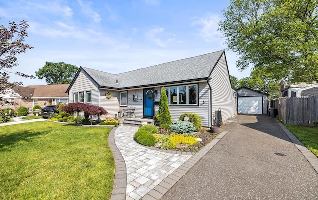 714 Barkley Ave, East Meadow, NY 11554 - view of front of house featuring asphalt driveway, a detached garage, roof with shingles, and an outdoor structure