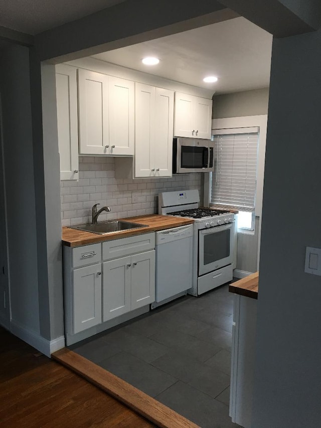 10 Dorothy Ct, South Merrick, NY 11566 - kitchen featuring butcher block countertops, white appliances, backsplash, white cabinetry, and recessed lighting
