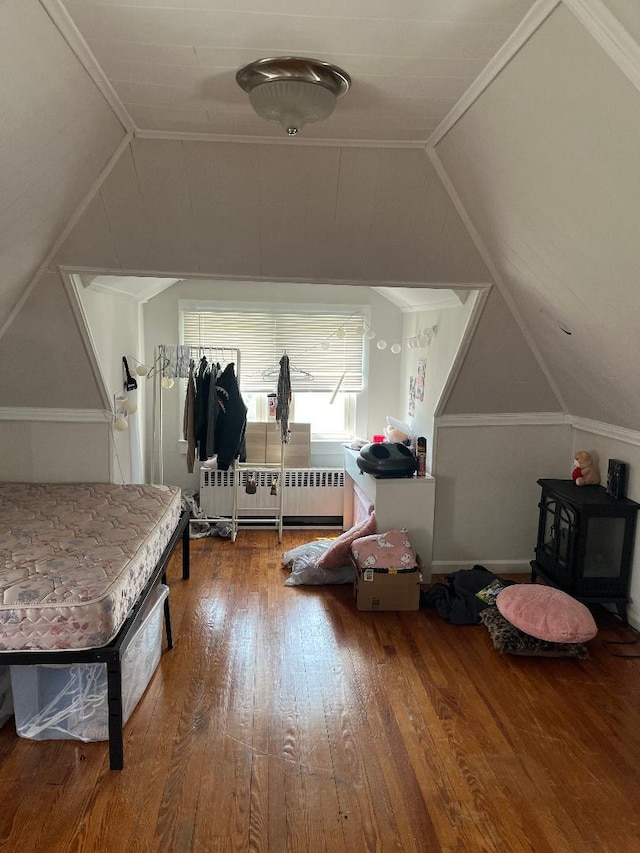 10 Dorothy Ct, South Merrick, NY 11566 - additional living space featuring vaulted ceiling, hardwood / wood-style flooring, and radiator