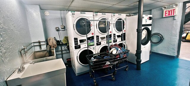 6615 Wetherole St Unit D12, Rego Park, NY 11374 - community laundry room with stacked washer and clothes dryer, a textured wall, and separate washer and dryer