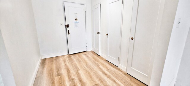 6615 Wetherole St Unit D12, Rego Park, NY 11374 - hall featuring light wood-style flooring and baseboards