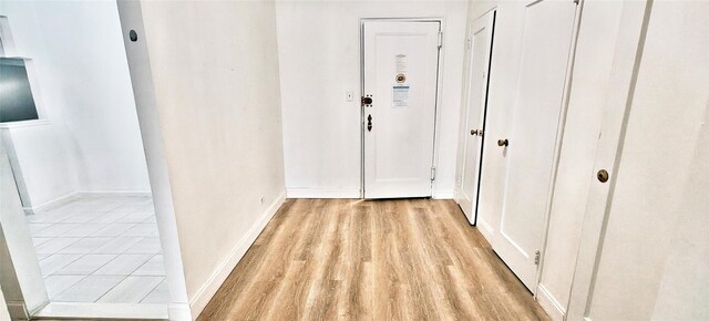 6615 Wetherole St Unit D12, Rego Park, NY 11374 - hallway featuring light wood-style floors and baseboards