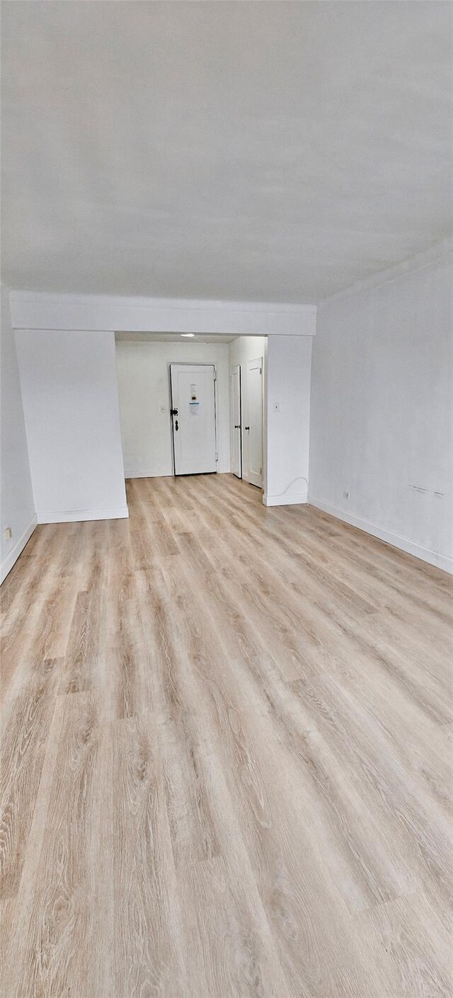6615 Wetherole St Unit D12, Rego Park, NY 11374 - spare room featuring light wood-type flooring and baseboards