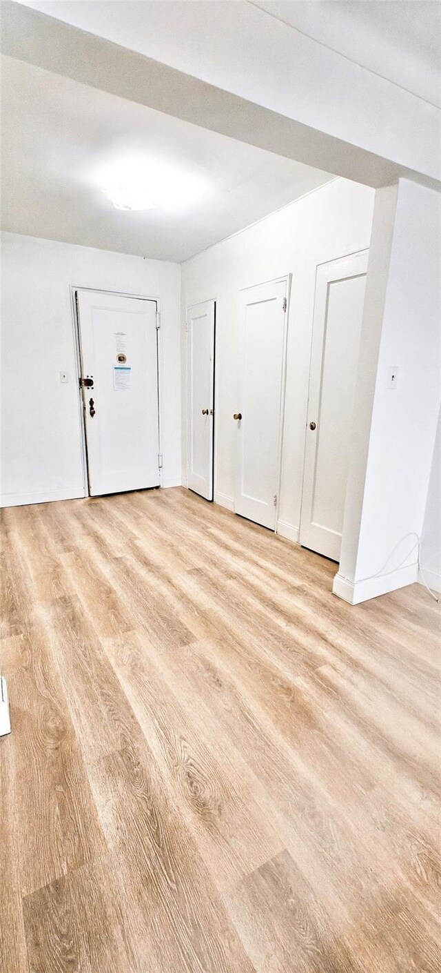 6615 Wetherole St Unit D12, Rego Park, NY 11374 - foyer with light wood-style flooring and baseboards
