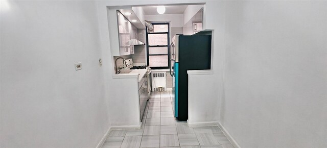 6615 Wetherole St Unit D12, Rego Park, NY 11374 - hall featuring baseboards and radiator