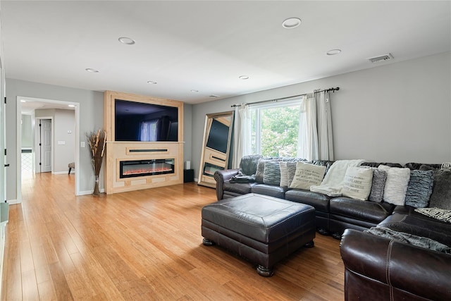 22 Pomper Dr, East Northport, NY 11731 - living room featuring light wood-type flooring, a large fireplace, and recessed lighting