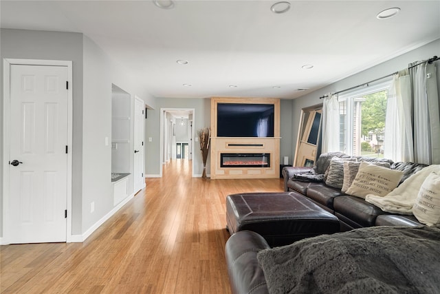 22 Pomper Dr, East Northport, NY 11731 - living room with a glass covered fireplace, light wood-style floors, and recessed lighting