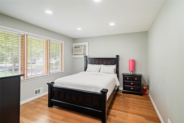 22 Pomper Dr, East Northport, NY 11731 - bedroom featuring a wall unit AC, light wood finished floors, and recessed lighting