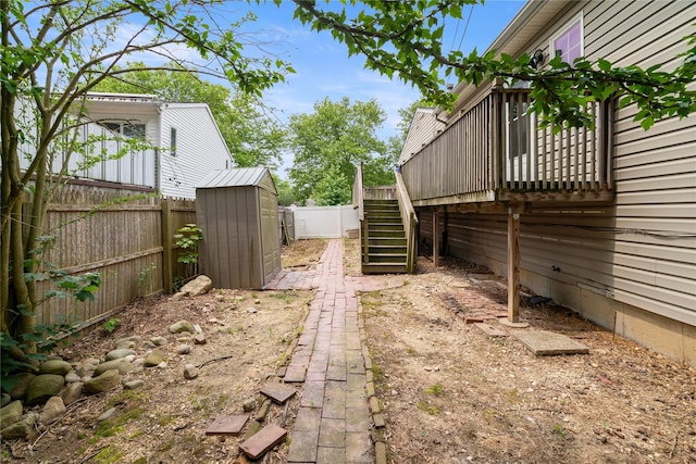 22 Pomper Dr, East Northport, NY 11731 - fenced backyard with stairway, a storage unit, and a deck