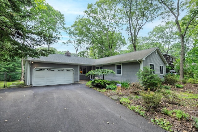 101 Wilson Dr, Port Jefferson Village, NY 11777 - ranch-style house with a garage, asphalt driveway, a chimney, and a shingled roof