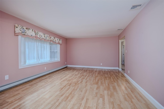 101 Wilson Dr, Port Jefferson Village, NY 11777 - spare room with baseboard heating and wood finished floors