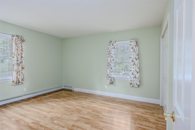 101 Wilson Dr, Port Jefferson Village, NY 11777 - unfurnished room with light wood finished floors, a baseboard heating unit, and plenty of natural light