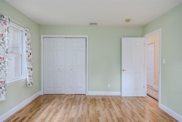 101 Wilson Dr, Port Jefferson Village, NY 11777 - unfurnished bedroom featuring light wood-style floors, a closet, and multiple windows