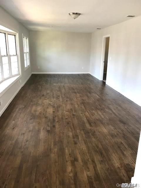 5 Fruitwood Ln, Commack, NY 11725 - unfurnished room featuring dark wood-style flooring and baseboards