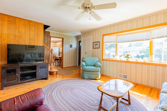 1668 Manatuck Blvd, Bay Shore, NY 11706 - living area with wood finished floors, wallpapered walls, ornamental molding, and ceiling fan