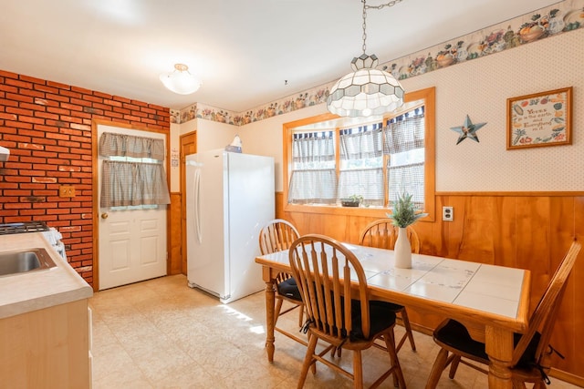 1668 Manatuck Blvd, Bay Shore, NY 11706 - dining space featuring light floors, a wainscoted wall, wood walls, and wallpapered walls