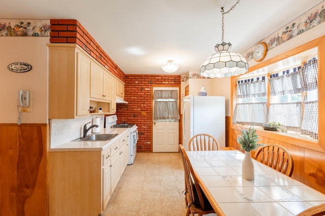 1668 Manatuck Blvd, Bay Shore, NY 11706 - kitchen featuring white appliances, tile countertops, under cabinet range hood, brick wall, and light flooring