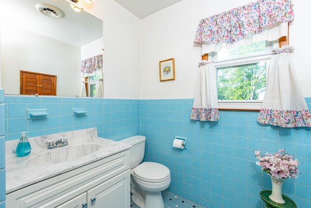 1668 Manatuck Blvd, Bay Shore, NY 11706 - bathroom featuring tile walls, tile patterned floors, vanity, and a wainscoted wall
