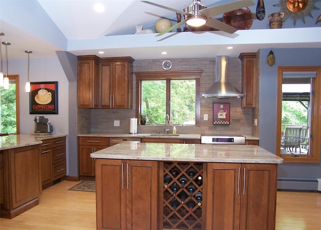 1778 Spur Dr S, Islip, NY 11751 - kitchen featuring wall chimney range hood, a baseboard heating unit, light wood finished floors, brown cabinetry, and decorative backsplash