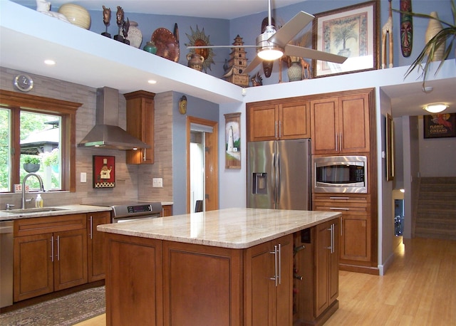 1778 Spur Dr S, Islip, NY 11751 - kitchen featuring stainless steel appliances, wall chimney exhaust hood, brown cabinets, decorative backsplash, and recessed lighting