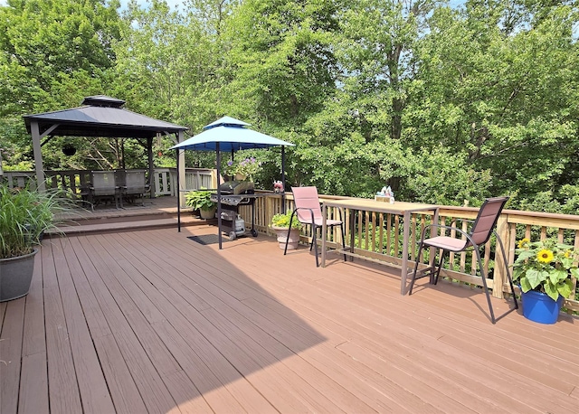 1778 Spur Dr S, Islip, NY 11751 - wooden deck with a gazebo, outdoor dining space, grilling area, and view of wooded area