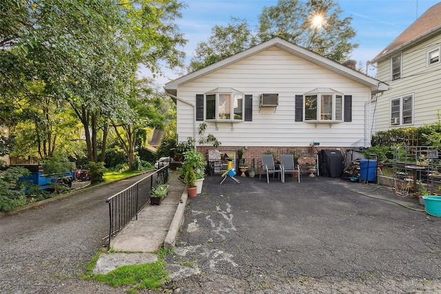 1222 Brook St, Peekskill, NY 10566 - view of front facade with a patio and a wall unit AC