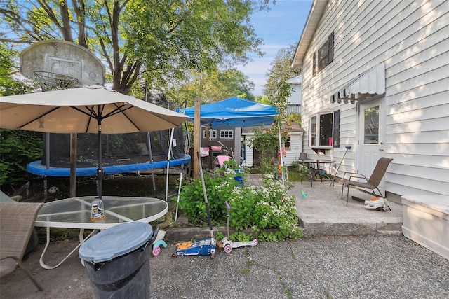 1222 Brook St, Peekskill, NY 10566 - view of yard featuring a trampoline, a patio area, and a storage unit