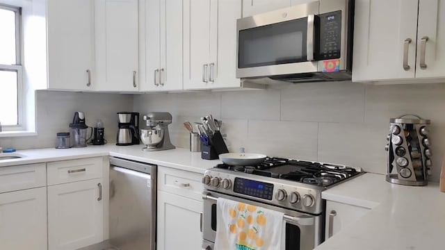 67-38 108st St Unit A53, Forest Hills, NY 11375 - kitchen with stainless steel appliances, tasteful backsplash, white cabinetry, and light countertops