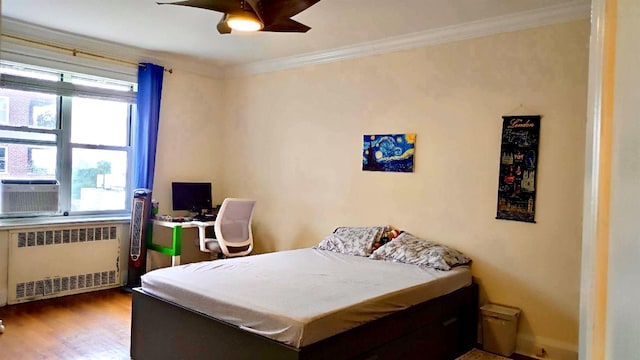 67-38 108st St Unit A53, Forest Hills, NY 11375 - bedroom featuring radiator, multiple windows, wood finished floors, crown molding, and ceiling fan