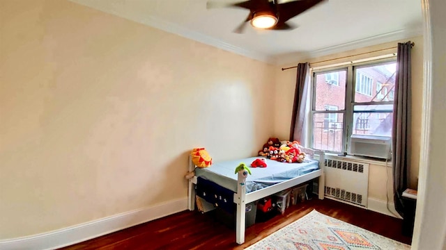 67-38 108st St Unit A53, Forest Hills, NY 11375 - bedroom featuring radiator heating unit, wood finished floors, ornamental molding, and a ceiling fan