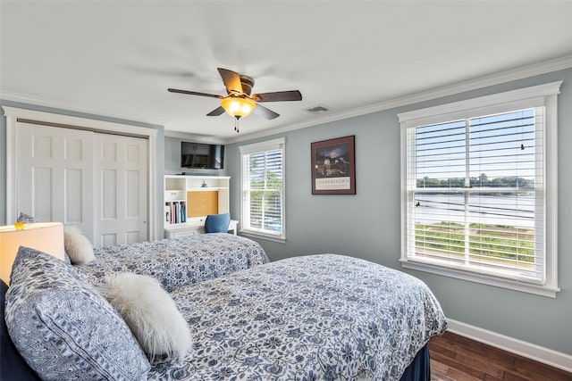 16 Dyke Rd, Setauket, NY 11733 - bedroom featuring dark wood-style floors, a closet, crown molding, and ceiling fan