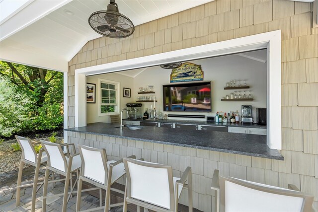 16 Dyke Rd, Setauket, NY 11733 - indoor wet bar featuring lofted ceiling and ornamental molding