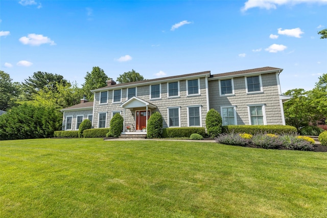 16 Dyke Rd, Setauket, NY 11733 - colonial home featuring a chimney and a front yard
