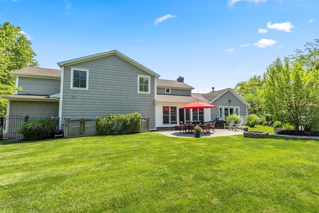 16 Dyke Rd, Setauket, NY 11733 - rear view of house featuring a patio area, a chimney, a fire pit, and roof with shingles
