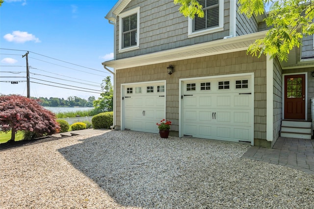 16 Dyke Rd, Setauket, NY 11733 - garage with driveway and a water view