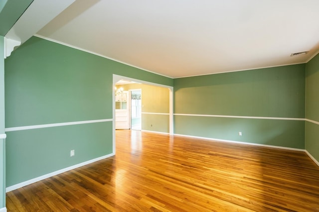76 Roebling Pl E, Northport, NY 11731 - empty room with a chandelier, crown molding, and wood finished floors