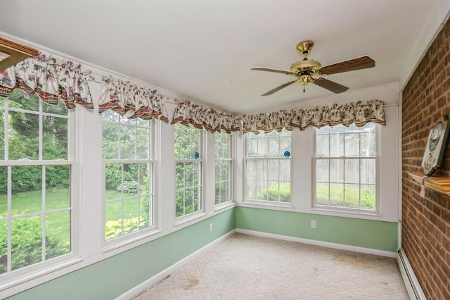 76 Roebling Pl E, Northport, NY 11731 - unfurnished sunroom featuring a baseboard heating unit, healthy amount of natural light, carpet flooring, and brick wall