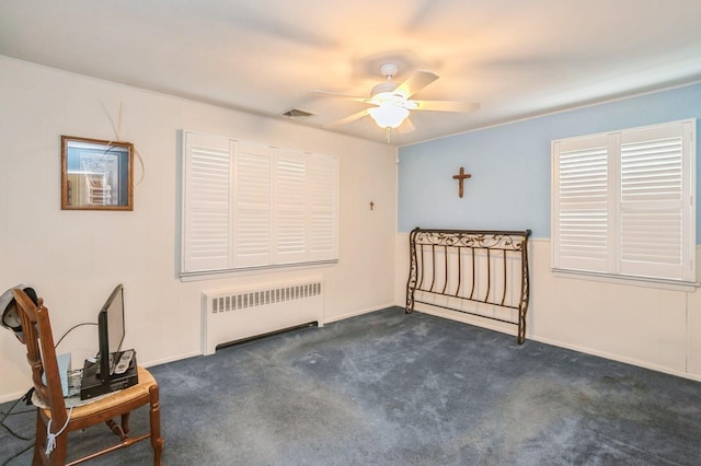 76 Roebling Pl E, Northport, NY 11731 - unfurnished bedroom with radiator heating unit, dark colored carpet, and a ceiling fan