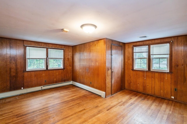76 Roebling Pl E, Northport, NY 11731 - spare room with healthy amount of natural light, wood finished floors, and wooden walls