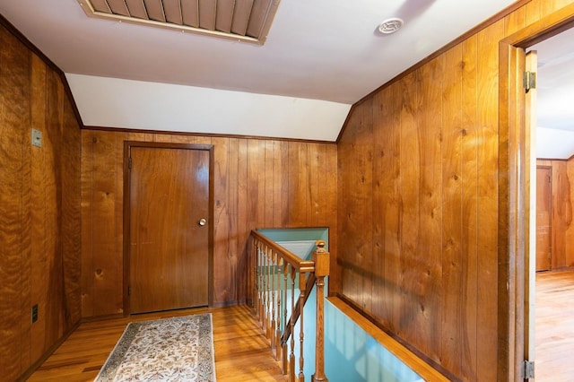 76 Roebling Pl E, Northport, NY 11731 - hallway featuring an upstairs landing, wood finished floors, and wood walls