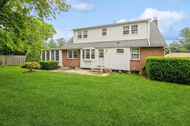76 Roebling Pl E, Northport, NY 11731 - rear view of property with brick siding, entry steps, a chimney, and roof with shingles