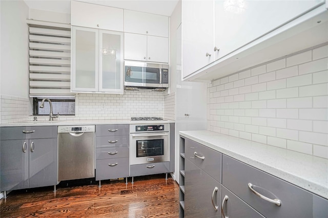 237 Eldridge St Unit 3 & 4, New York Manhattan, NY 10002 - kitchen with appliances with stainless steel finishes, gray cabinets, backsplash, and light countertops