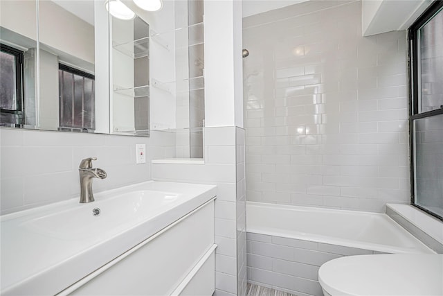 237 Eldridge St Unit 3 & 4, New York Manhattan, NY 10002 - bathroom with tiled shower / bath combo, vanity, and tile walls